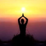 Practicing yoga as the sun falls