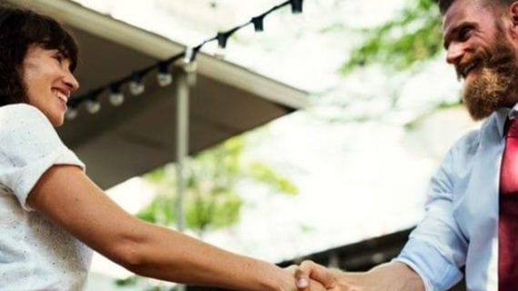 Man and woman shaking hands When strangers meet and civility reigns